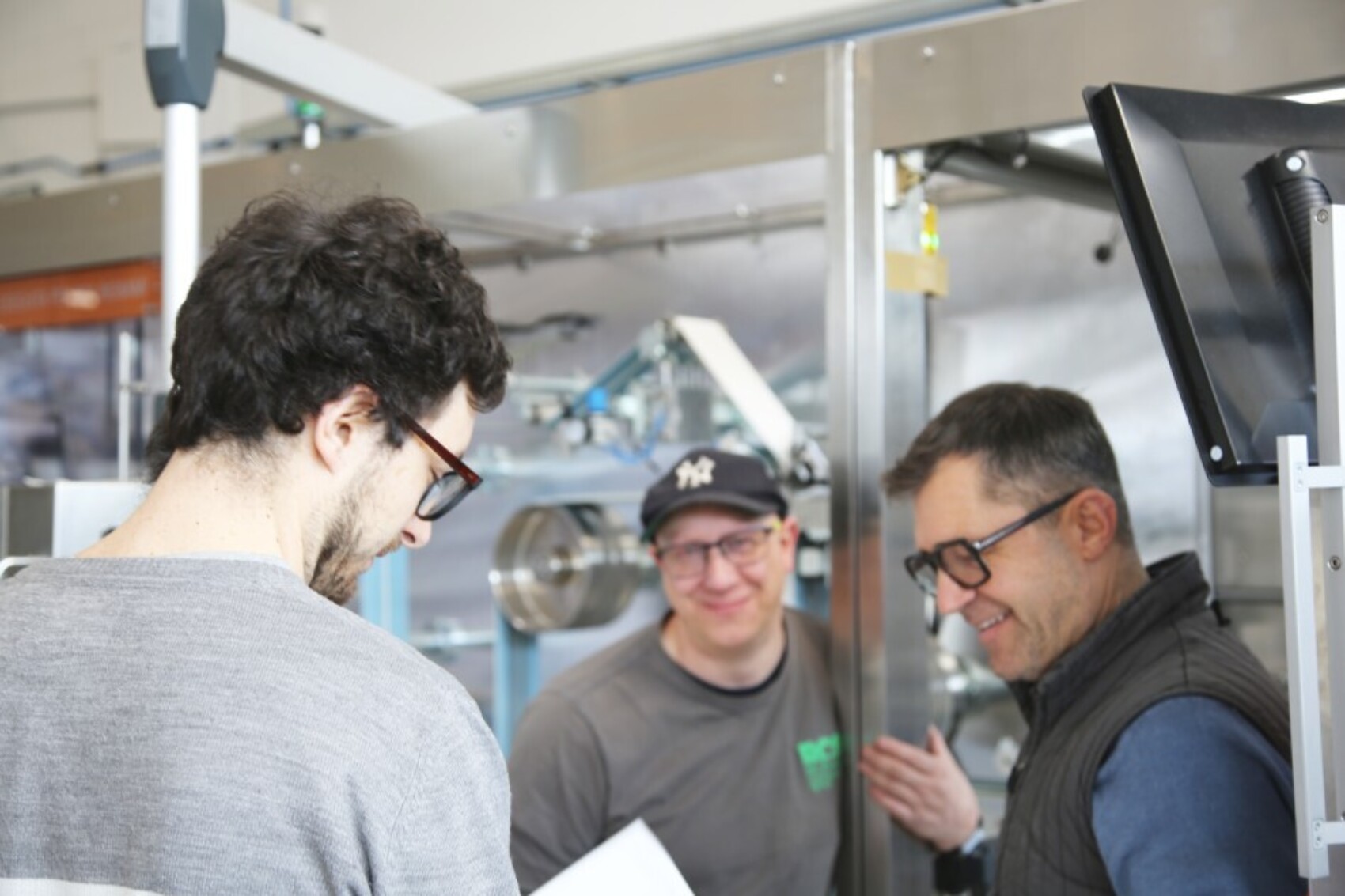 Giorgio Bignami with two other persons in front of a converting machine